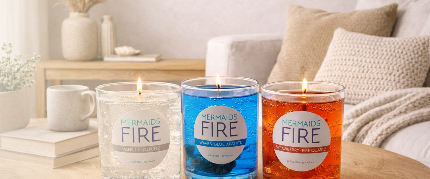 Four candles labeled 'Mermaid's Fire' on a table with a cozy living room background